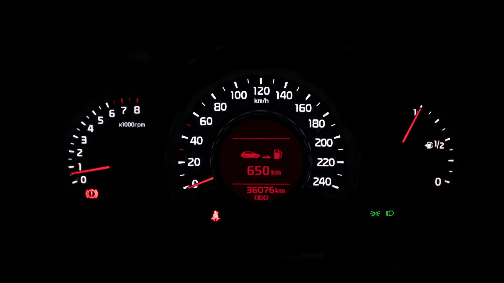 Car dashboard showing speed, RPM, fuel gauge, and 650 km remaining range.